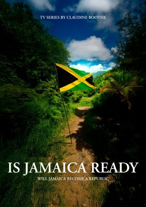 Jamaican flag waving on a path surrounded by greenery under a partly cloudy sky.