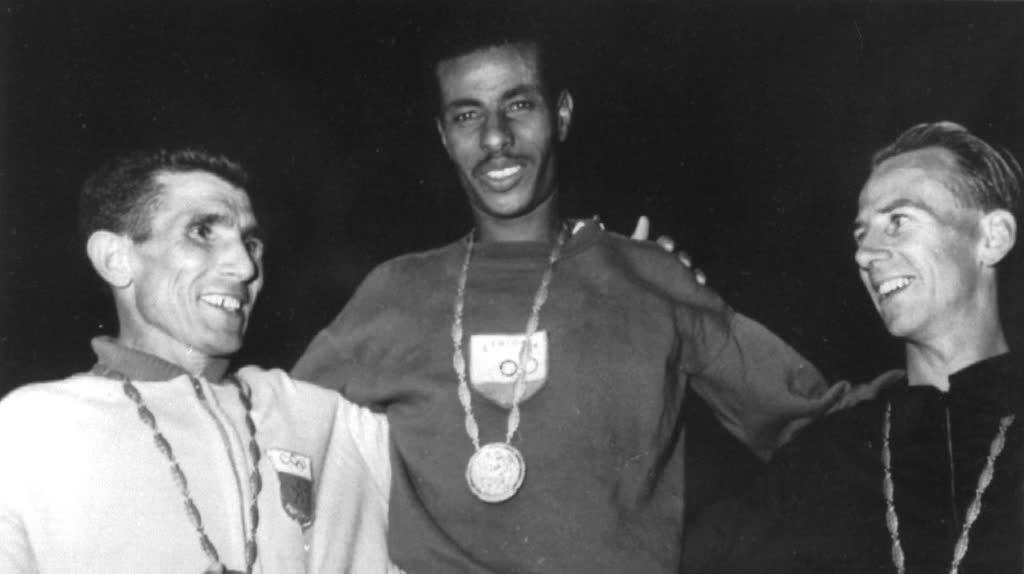 The three medallists of the 1960 Olympic marathon with their medals: Rhadi Ben Abdesselam, Abebe Bikila in the centre and Barry Magee