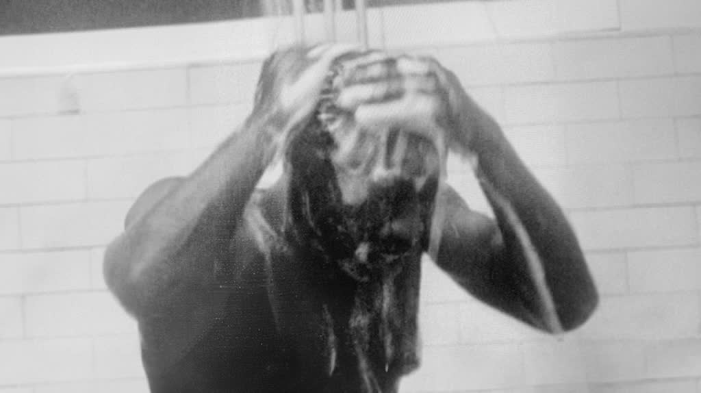 A Black miner washing off coal dust in the pithead baths, from Skin and Coal (1986)