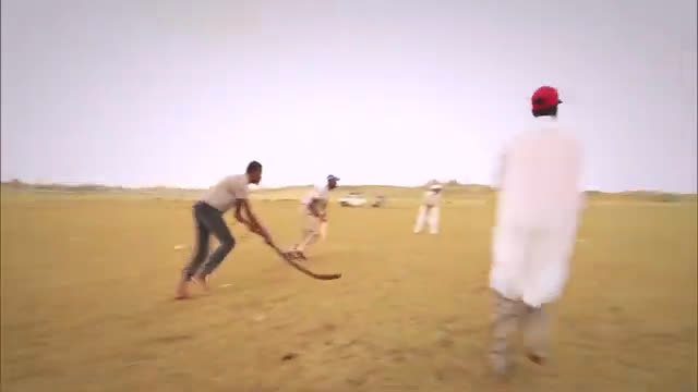 Players with curved sticks in a traditional stick-and-ball game on open sandy ground, from The African History of Sport
